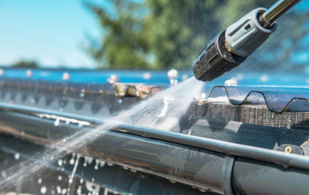 Cleaning gutter with jet wash
